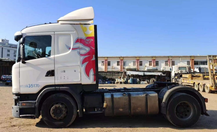 Rear side yard shot of well-preserved Scania G410 4x2 tractor truck.