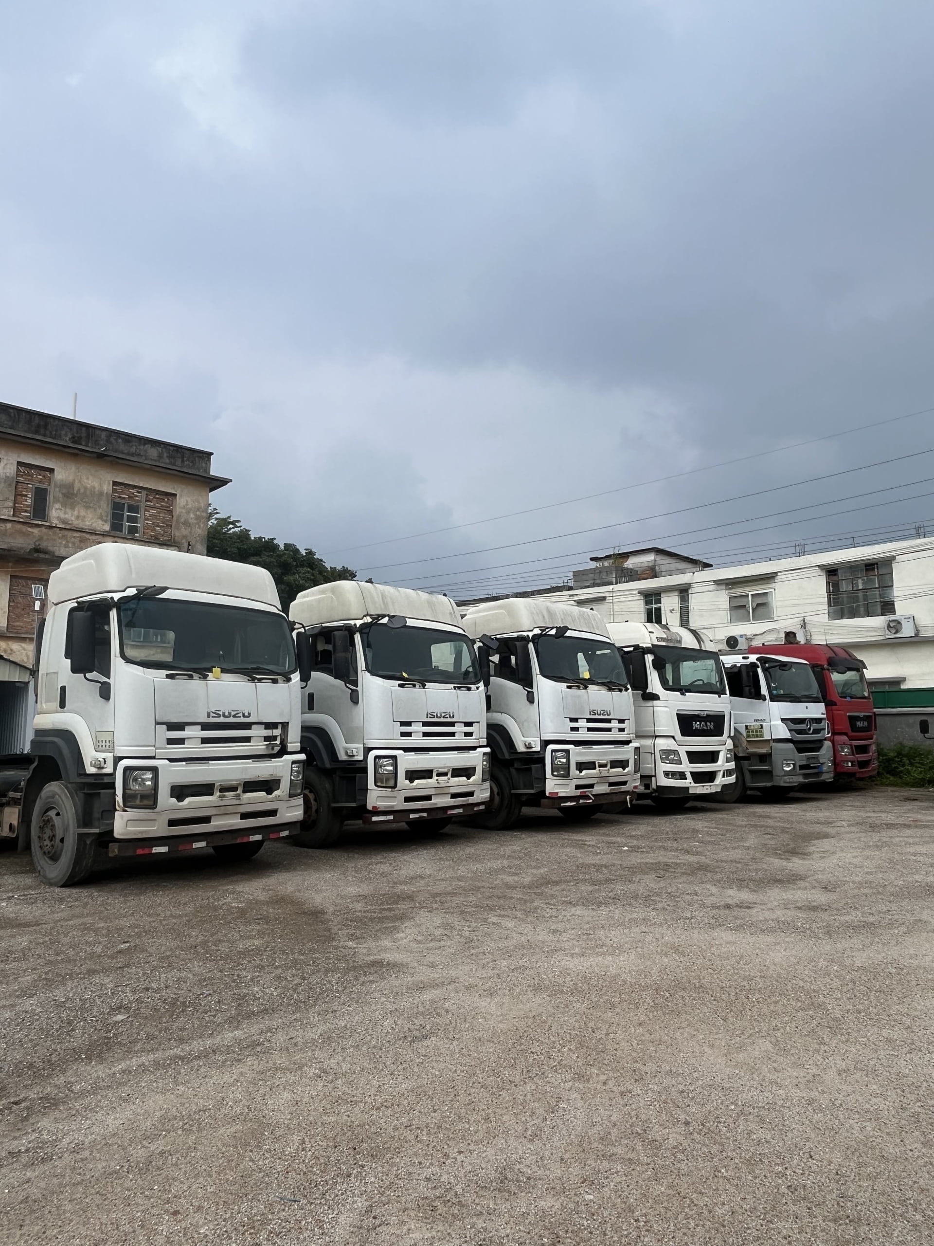 Used trucks ready for export at Deli Auto yard