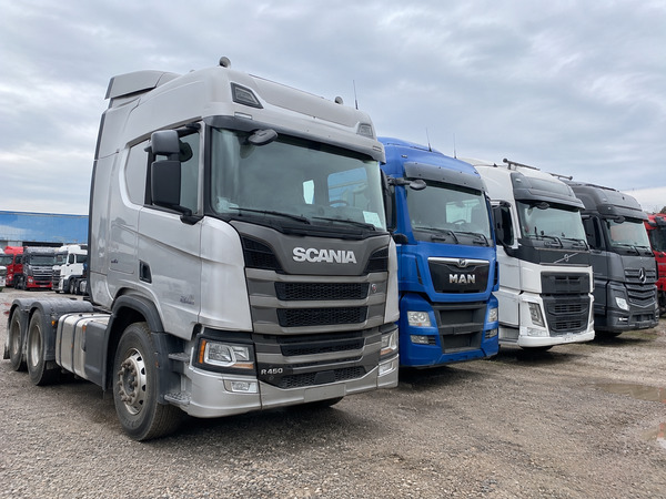 Used semi-trucks being inspected before purchase