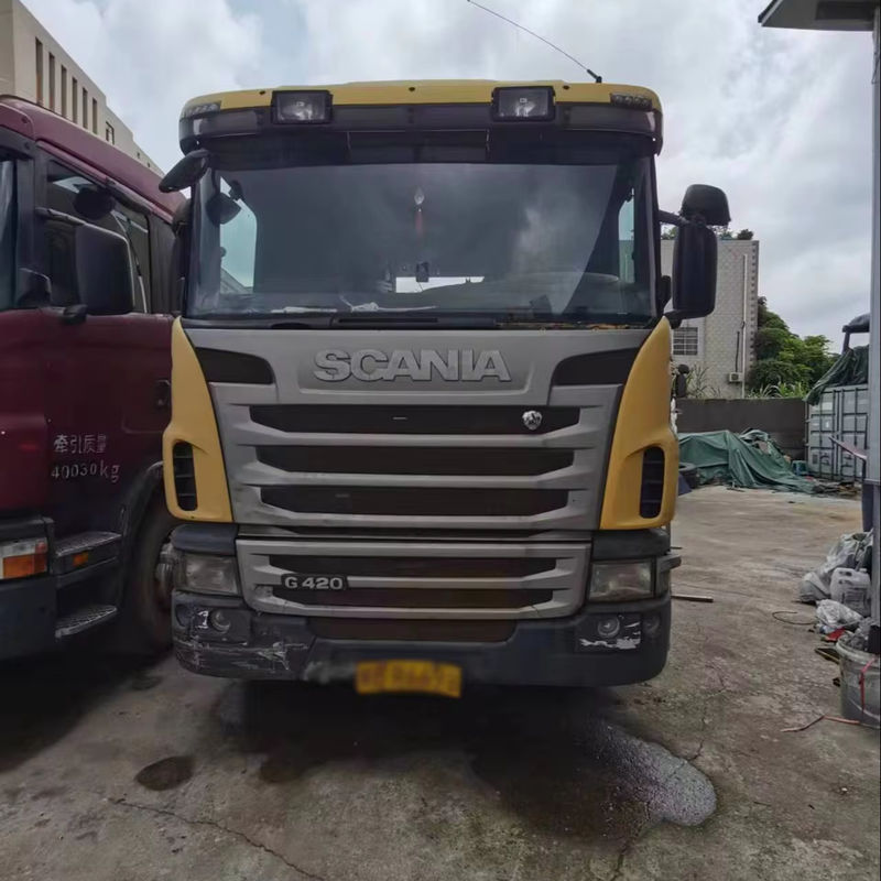 Factory price G420 used good condition tractor truck head for scania truck, 420HP heavy duty yellow tractor, left front 45 degree view storage yard scene