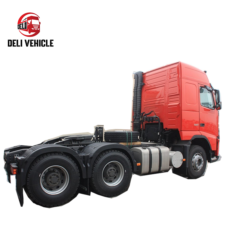 Left rear side view of high quality Volvo FH520 6*2 used truck, 520HP second hand trailer with red cab heavy duty tractor showing rear axles