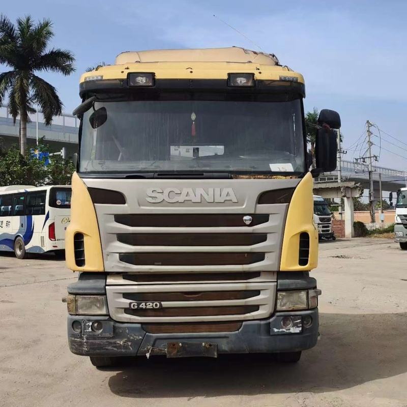 Used SCANIA G420 6x2 manual diesel heavy cargo tow truck front face view, outdoor industrial storage yard scene