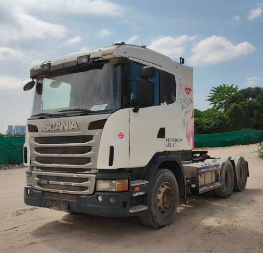 Used Scania G series heavy duty tractor truck left front close-up view, good condition second-hand commercial truck, outdoor storage yard scene