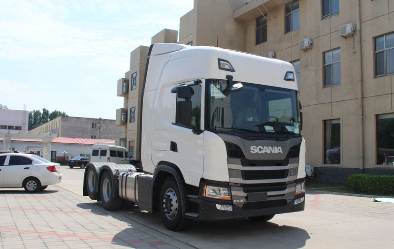 Second-hand SCANIA G500 super performance diesel tractor truck, left front 45 degree close-up view in industrial storage yard
