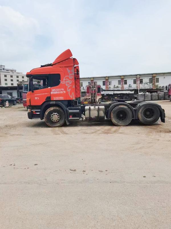 Used trailer truck head for SCANIA P380 sale high quality 6x2 tractor truck head, 380HP heavy duty orange tractor, left front 45 degree view outdoor storage yard
