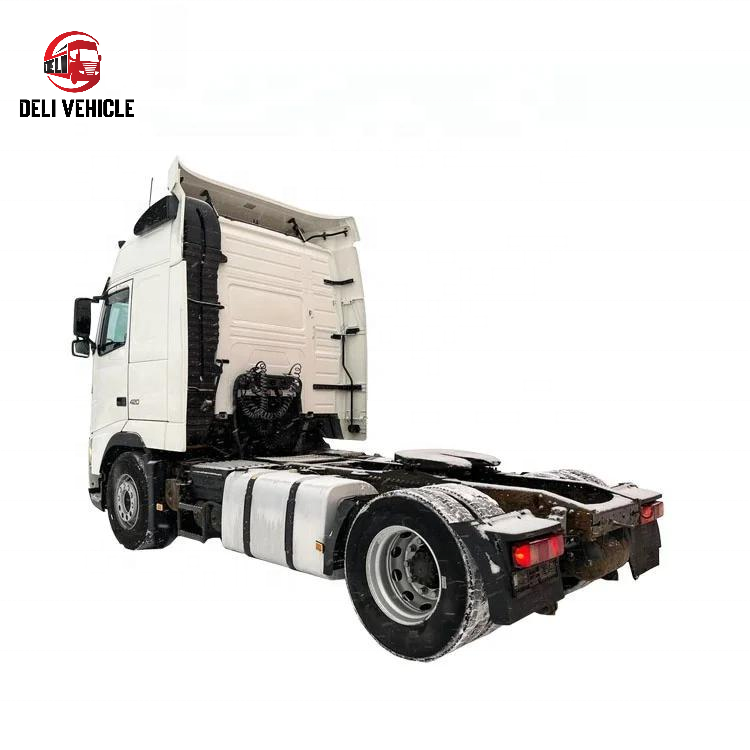 Left rear side view of second hand used trailer truck for VOLVO FH420 4x2 used tractor truck, 420HP heavy duty tractor head showing rear axles and lights