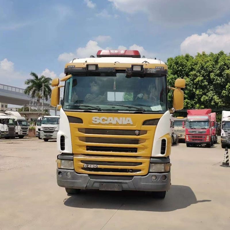 Second-hand SCANIA G420 6x2 heavy duty manual tractor, front face view outdoor storage yard scene