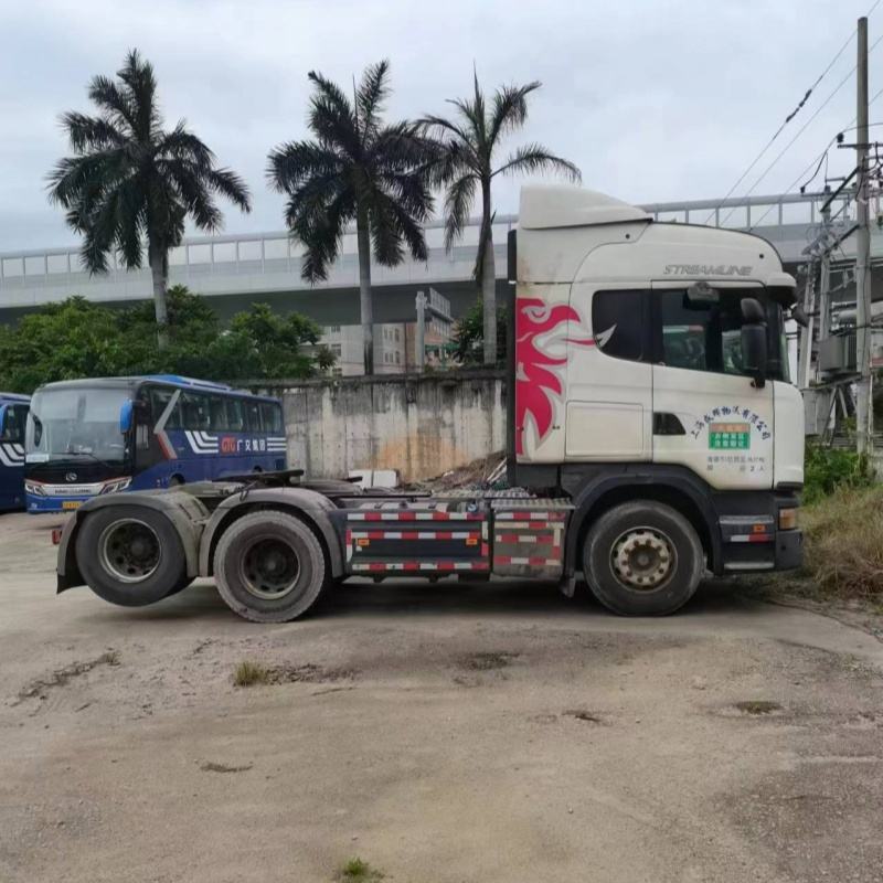 Second-hand SCANIA G440 6x2 heavy duty cargo tow truck, full right side view in industrial storage yard scene