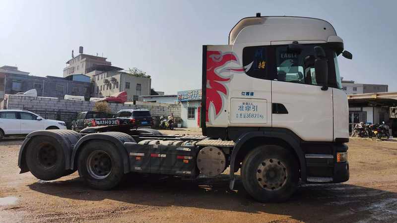 Super good performance used SCANIA G480 6X2 tractor truck, full left side view in industrial storage yard scene