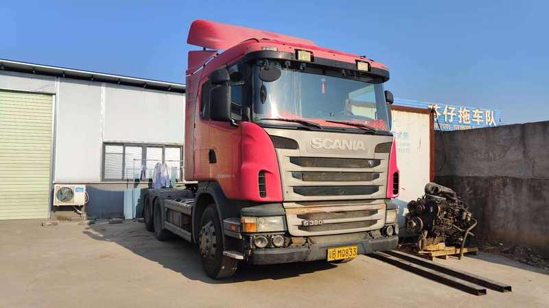 Cheap price 6x2 good condition wheel truck G380 for sale tractor used for scania truck, 380HP heavy duty red tractor, right front 45 degree view industrial yard scene