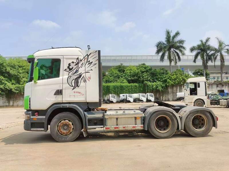 Cheap used Scania G420 heavy duty tractor truck full left side view, imported from Sweden second-hand truck, outdoor yard scene