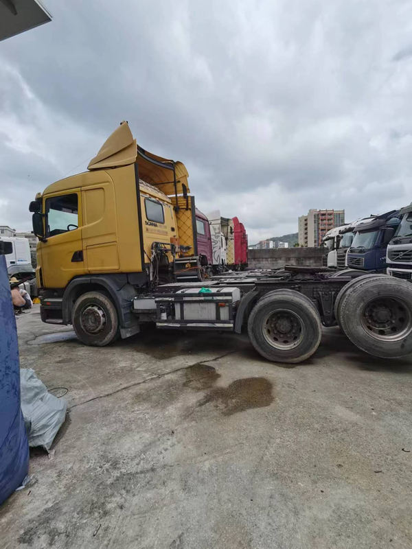 - Factory price G420 used good condition tractor truck head for scania truck, 420HP heavy duty yellow tractor, full right side view outdoor storage yard