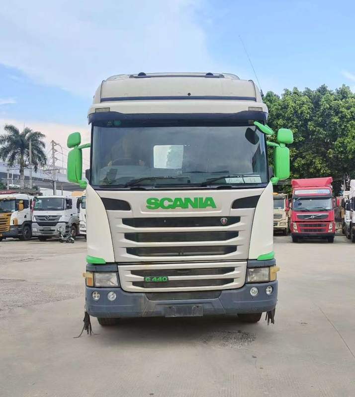 High quality 6x2 SCANIA G440 automatic tractor truck front face view, white green heavy duty tow truck, full outdoor storage yard scene