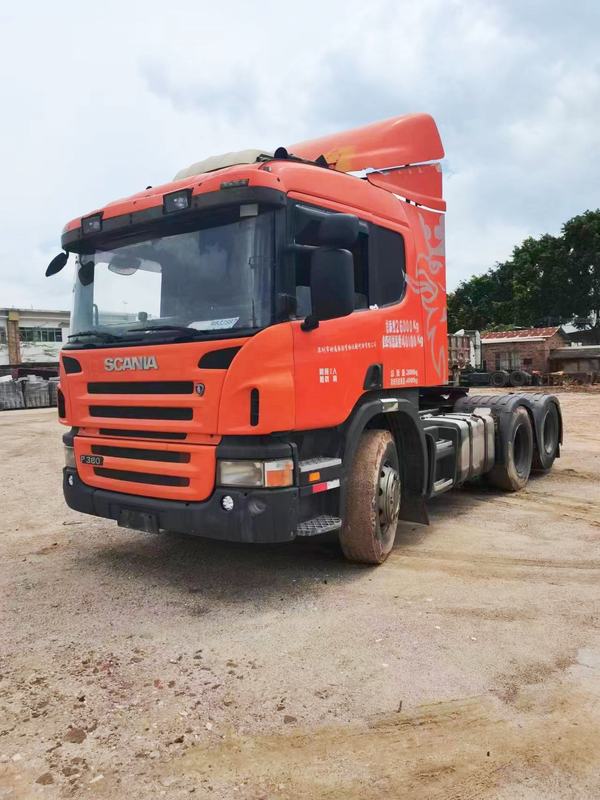 Used trailer truck head for SCANIA P380 sale high quality 6x2 tractor truck head, 380HP heavy duty orange tractor, right front 45 degree view outdoor yard scene