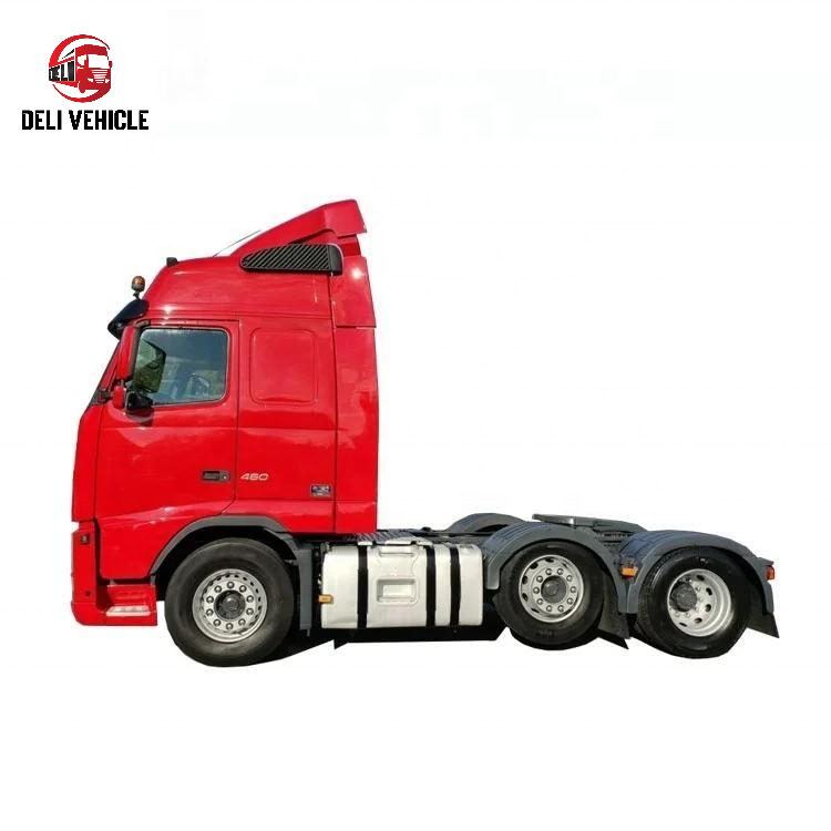 Left rear side view of second hand VOLVO FH460 6x2 used tractor truck, 460HP heavy duty used trailer truck with red cab showing rear axles