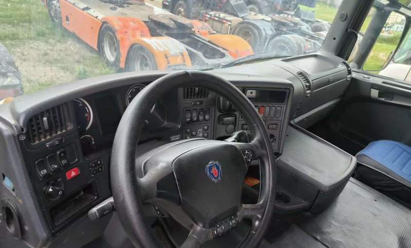 Used SCANIA G440 6x2 tractor truck cab interior view, showing steering wheel and driver dashboard, second-hand heavy truck cabin