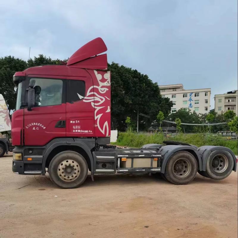 - Used SCANIA G440 6x2 diesel tractor truck second hand trailer head for road transport, 440HP heavy duty red diesel tractor, full right side view outdoor storage yard