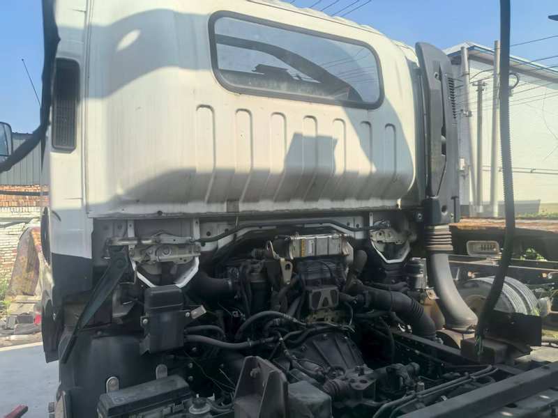 Side view of engine compartment of Isuzu 3 ton diesel wrecker tow truck