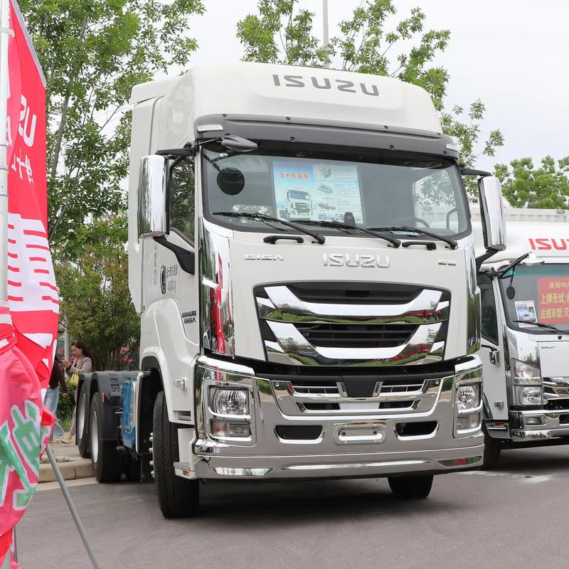 Left front side view of Isuzu Giga VC66 6x4 heavy-duty transport tractor truck with high roof cabin