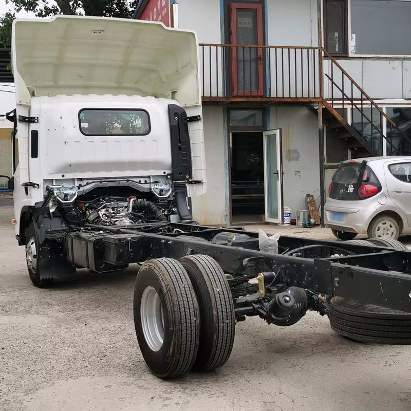 Left side view of used Isuzu KV 800 4x2 diesel truck chassis, showing frame and wheel structure