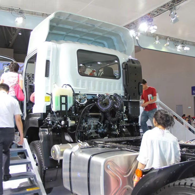 Left side view of used Isuzu VC46 6X4 tractor truck for Qingling, showing cab fairing panel at exhibition